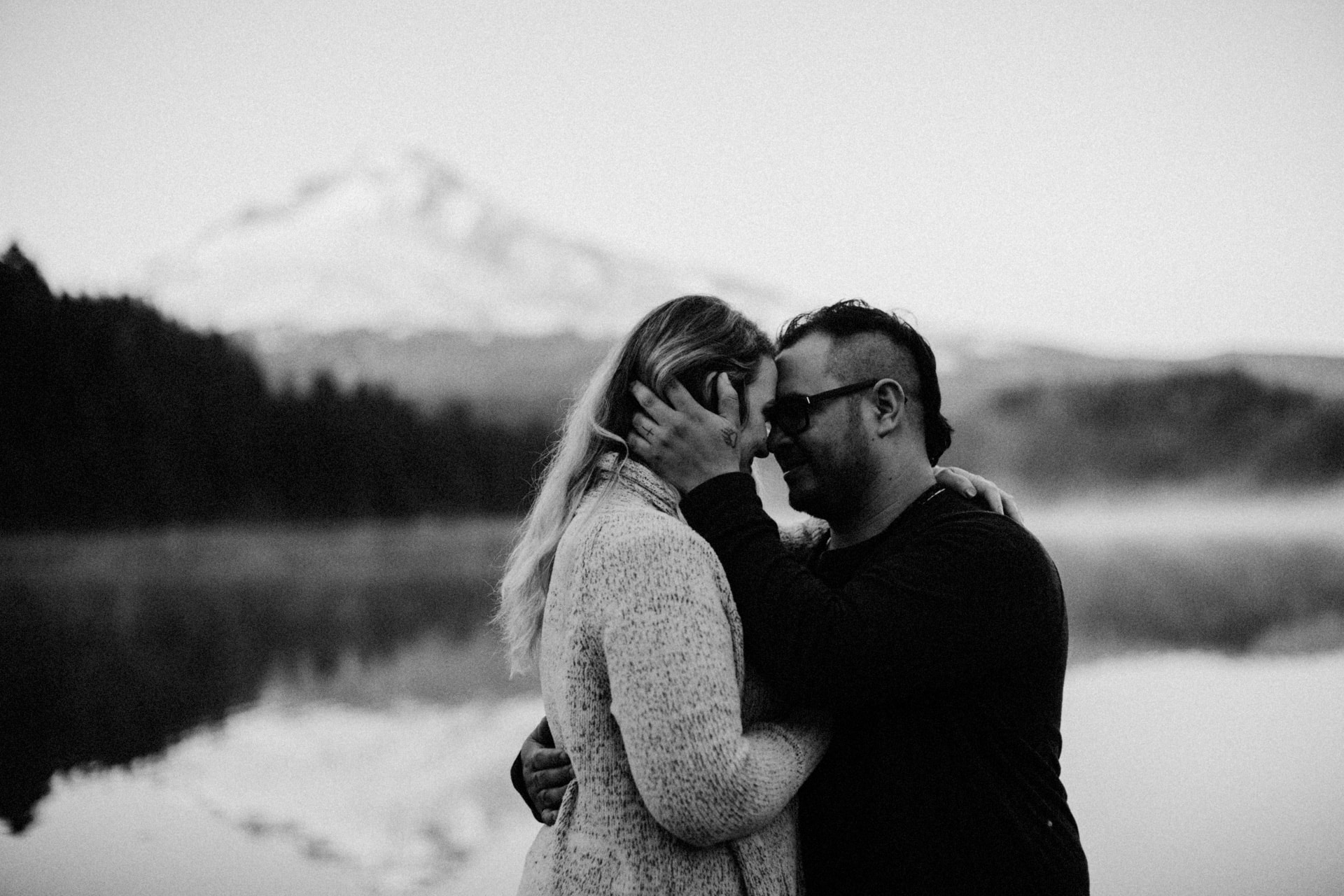 A couple embracing and smiling at Mount Hood